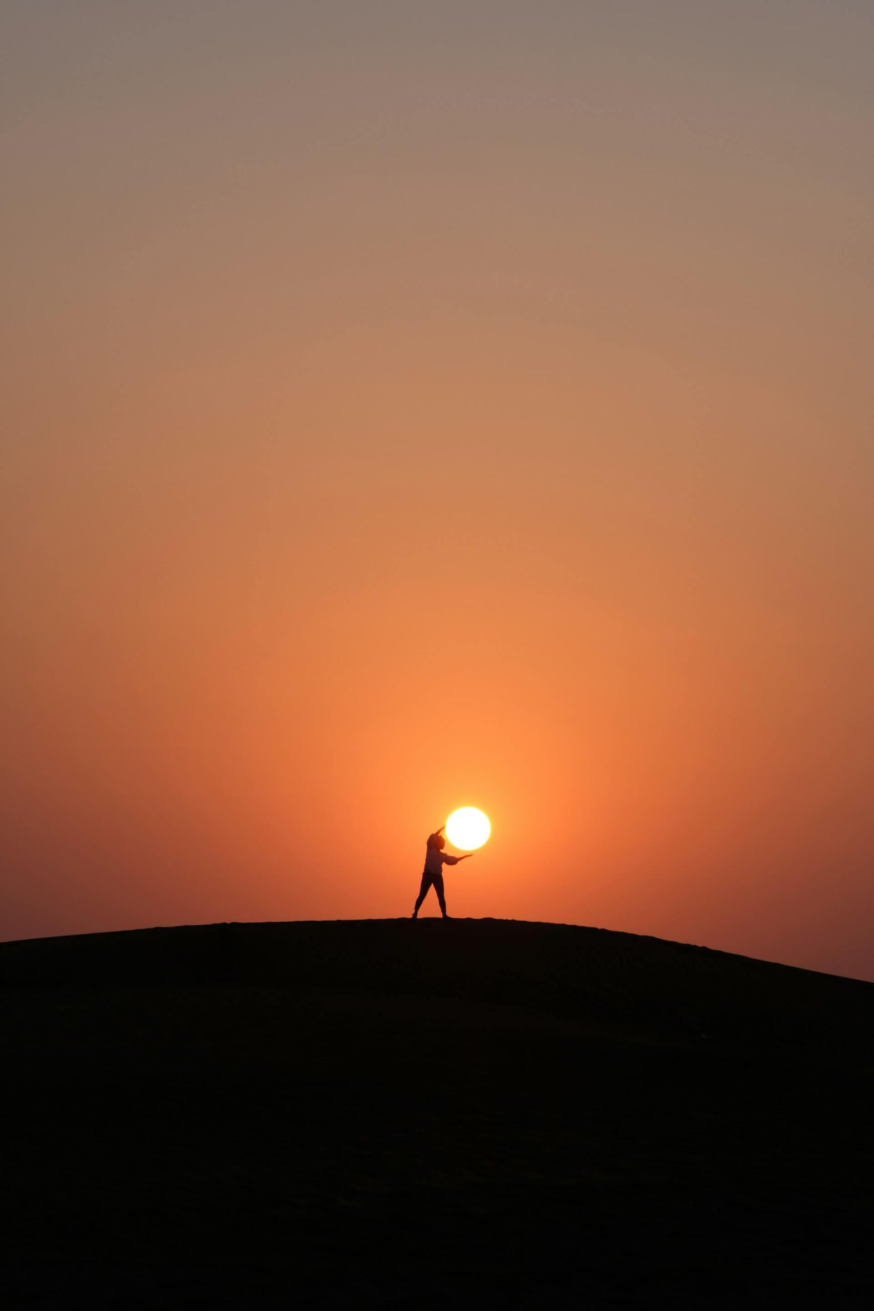 capturingthesun A trick image of someone "holding" the sun. The person is in the foreground with the sun in the background.