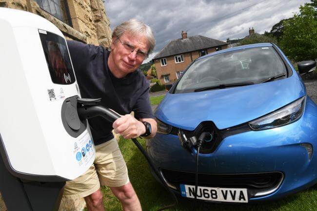 charging EV Man connecting his electric car to the charger